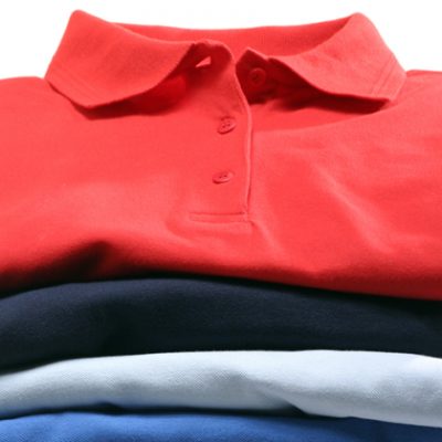 A stack of polo-shirts shot in the studio. The shirts are isolated in front of white background.